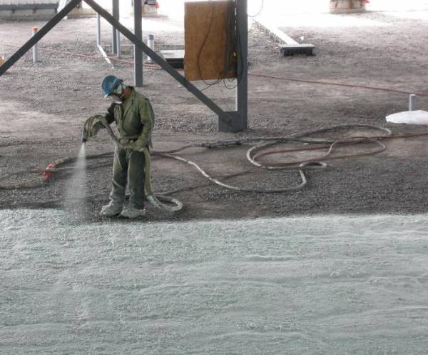 Closed-cell spray foam spraying for protection from Radon in large buildings.